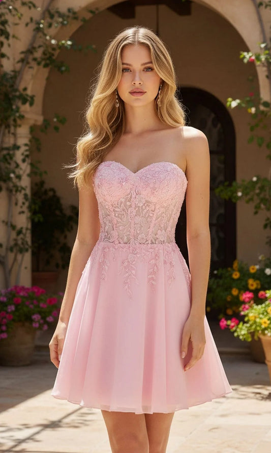 Model wearing a blush pink strapless A-line homecoming dress with a lace-up corset back.