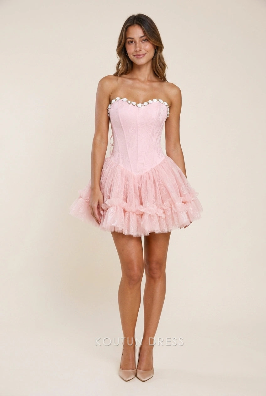 Pink strapless corset mini dress with lace-up back, rear view.
