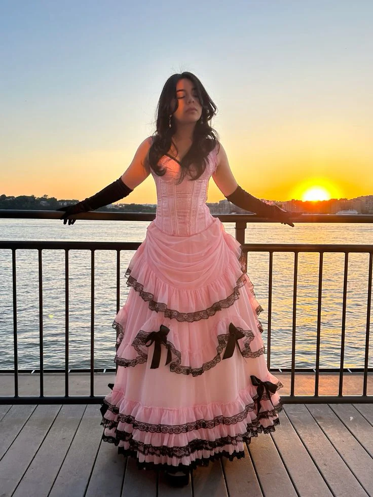 Evening Dress Sleeveless Pink Tulle Ball Gown with Corset Bodice Tiered Ruffle Skirt  Black Lace Trim and Bow Accents