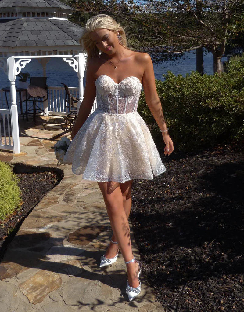 Model in purple A-line sweetheart mini homecoming dress.