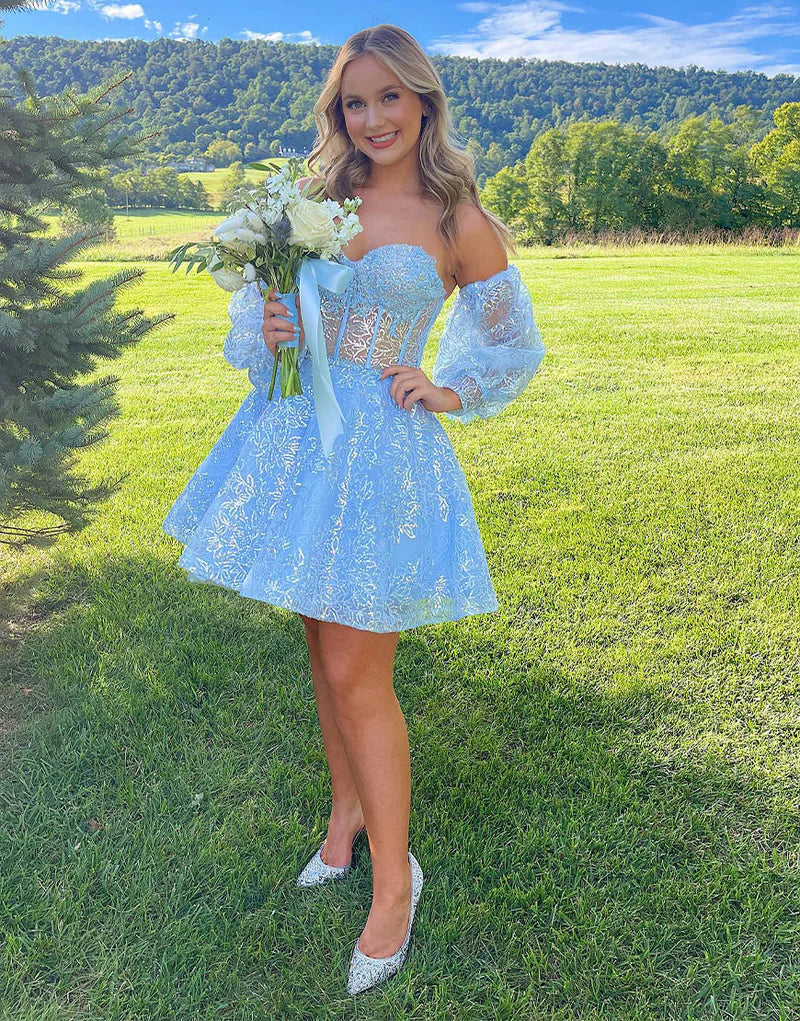 Model in black A-line sweetheart mini homecoming dress.
