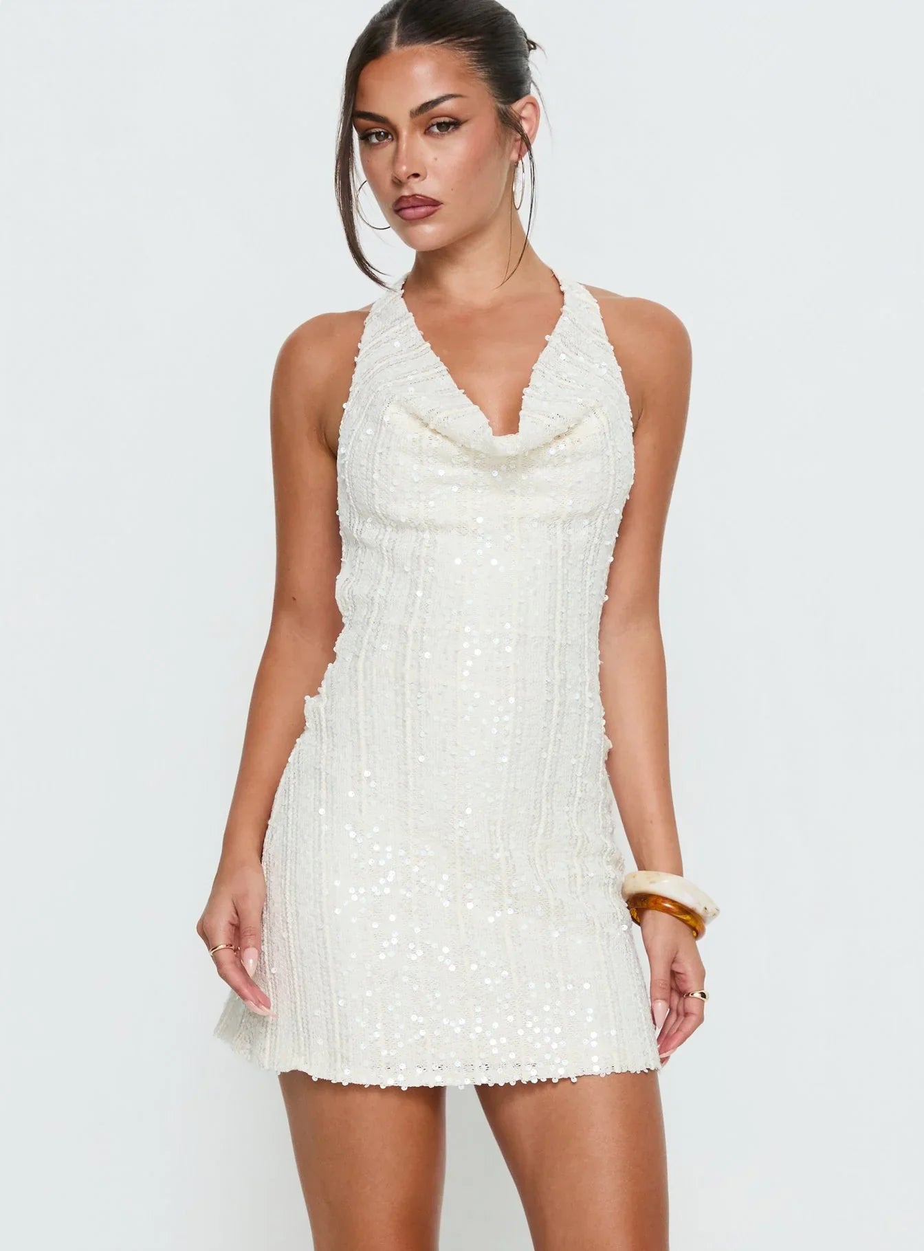 Back view of white halter dress showing crisscross straps.