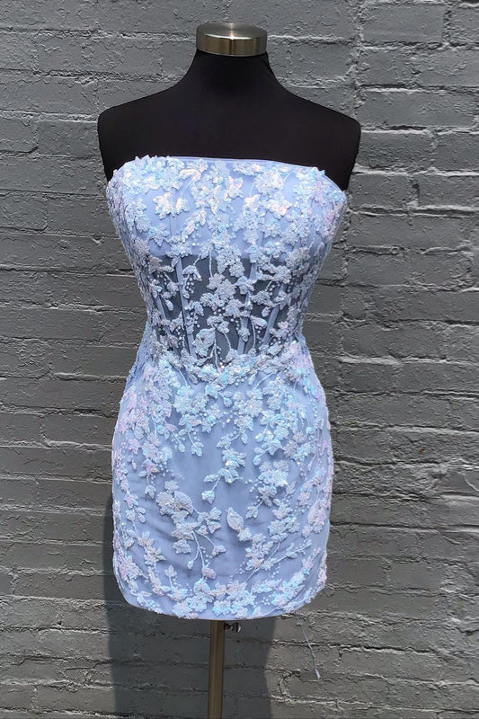 Model wearing a Koutun strapless blue sequin short homecoming dress.