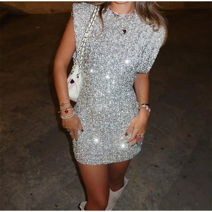 Close-up of the shimmering silver sequin fabric on the bodycon mini dress.