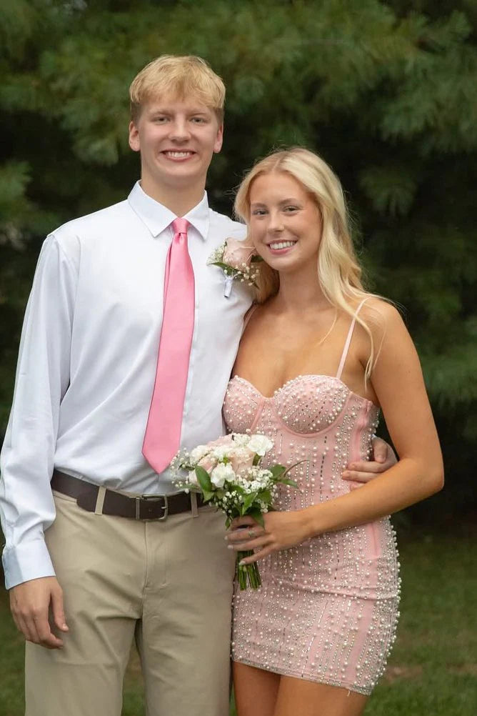 Close-up of a pink beaded bodycon dress with sweetheart neckline.