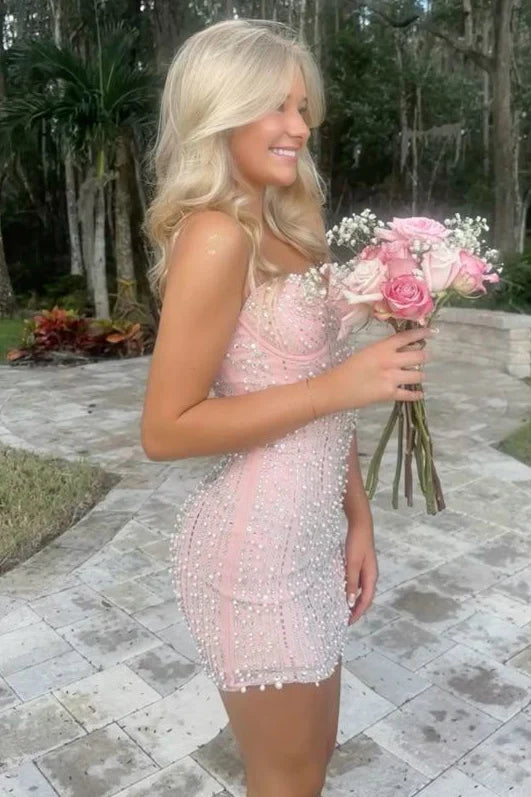 Back view of a pink strapless mini dress with corset detailing.