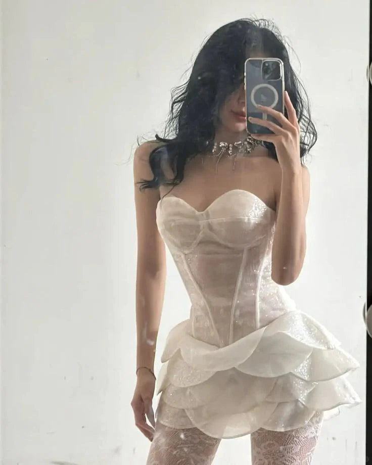 Ivory sweetheart strapless homecoming dress with corset bodice and tiered ruffle skirt.