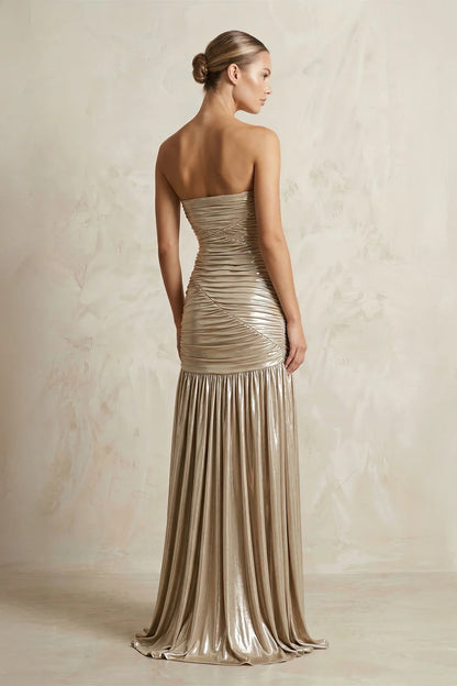 Side view of strapless metallic jersey gown with high slit.