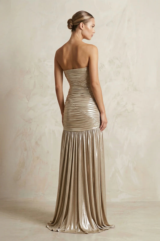 Side view of strapless metallic jersey gown with high slit.