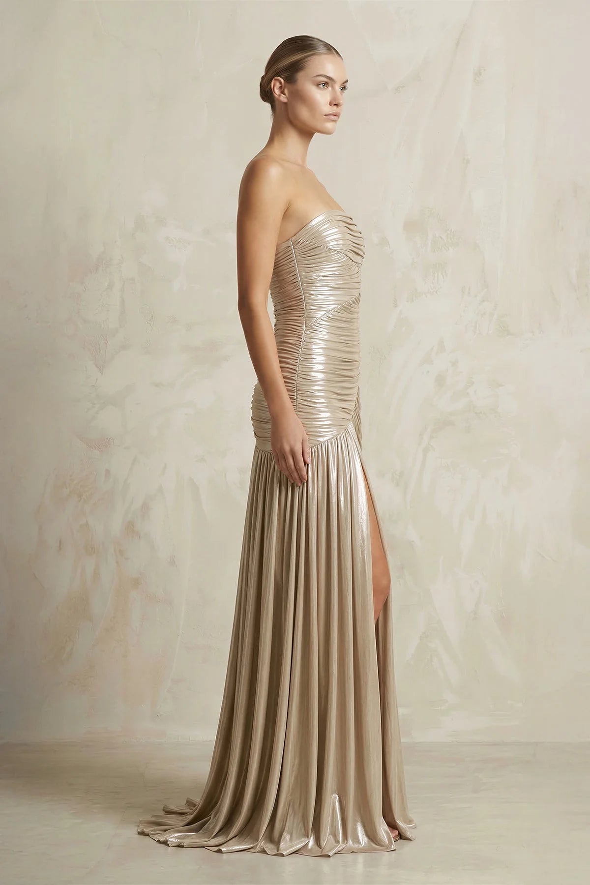 Back view of strapless ruched metallic jersey floor-length gown.