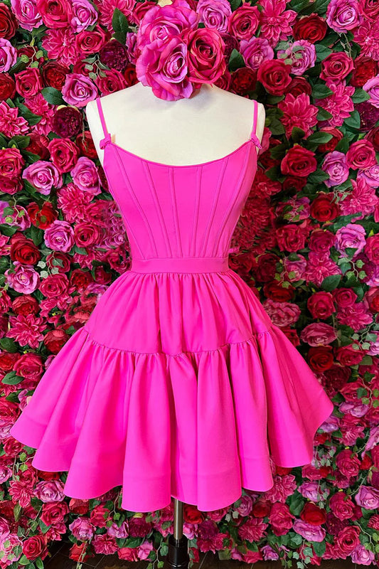 Model wearing a hot pink A-line ruffled lace-up homecoming dress, front view.