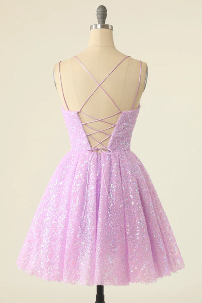 Full length view of the light green sequined dress, highlighting its short length and flow.