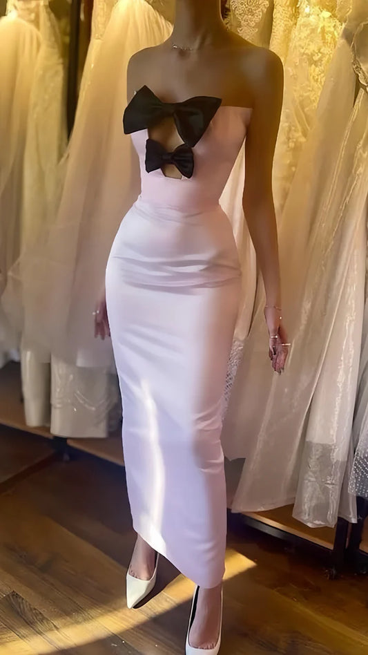 Model wearing a light pink bodycon strapless short party prom dress.