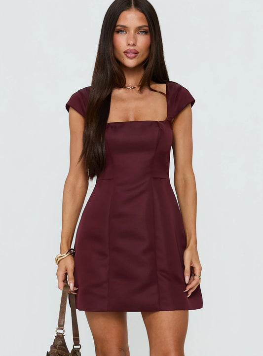 Burgundy cap sleeve homecoming dress with square neck and form-fitting silhouette.