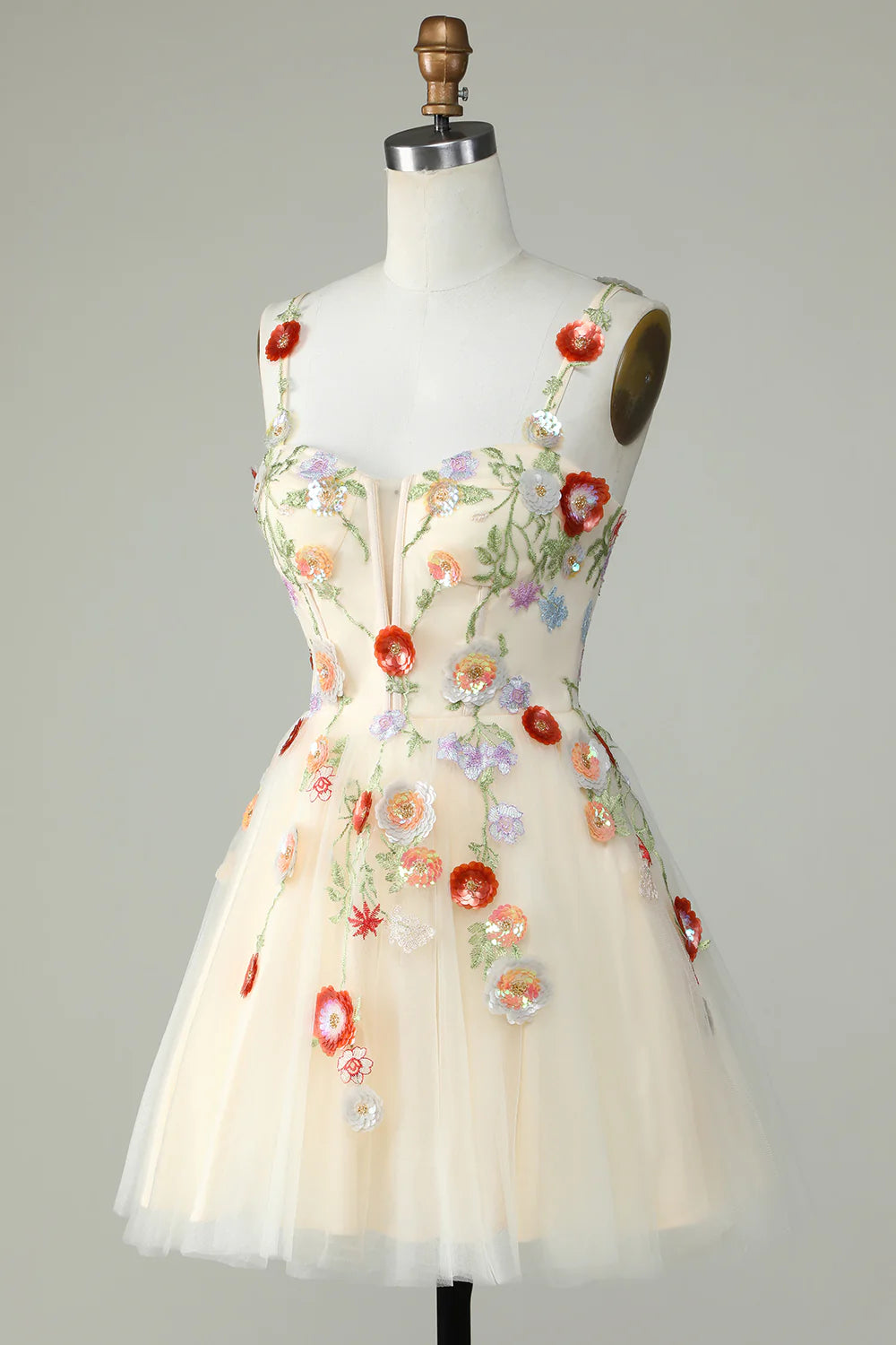 Champagne A-line mini dress with spaghetti straps and sequin details.