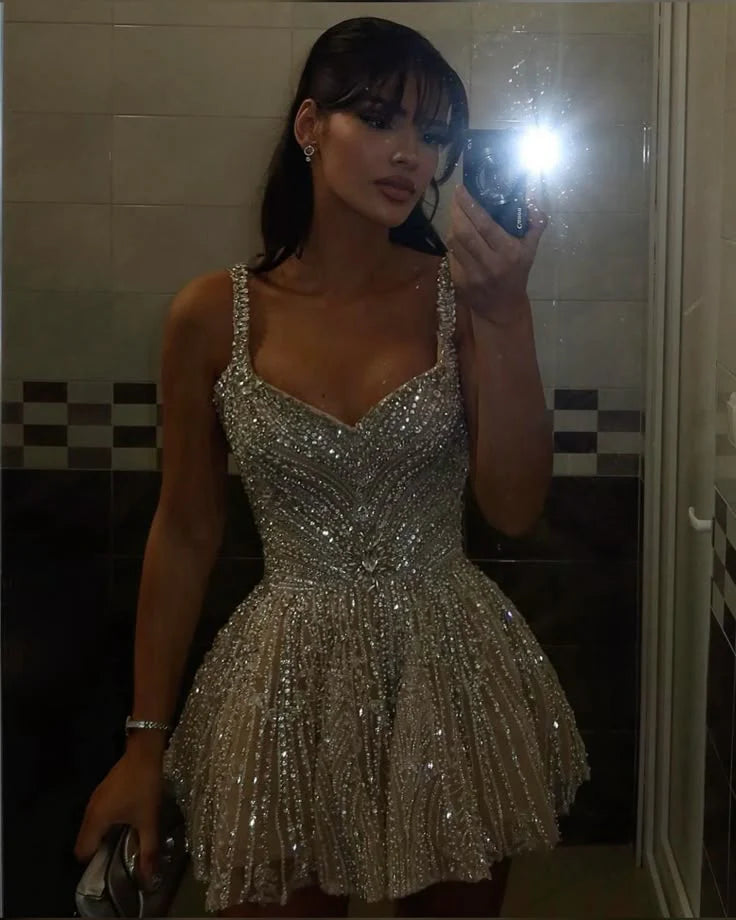 Side view of the short silver A-line dress, highlighting the flared skirt.