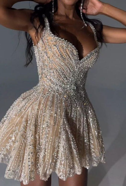 Detail of the wide beaded straps and sweetheart neckline of the silver dress.