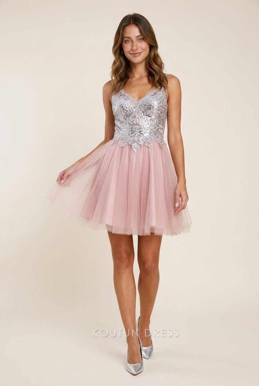 Model wearing a sparkling silver sequin and blush tulle A-line V-neck short homecoming dress.