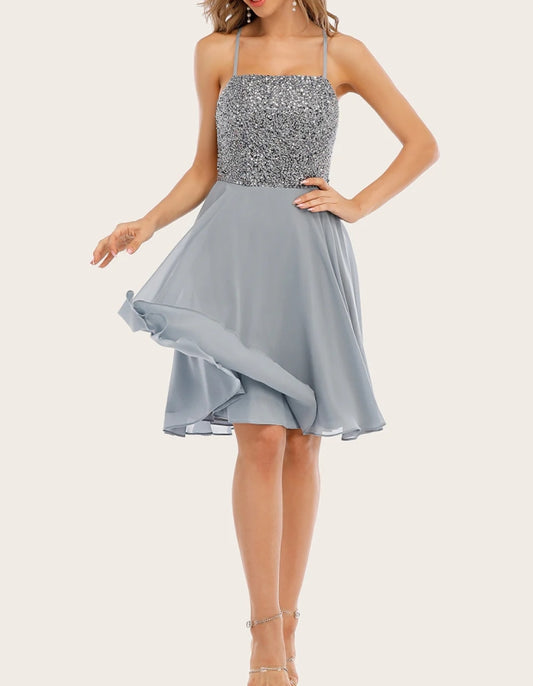 Model wearing a sparkling grey beaded short A-line homecoming dress.