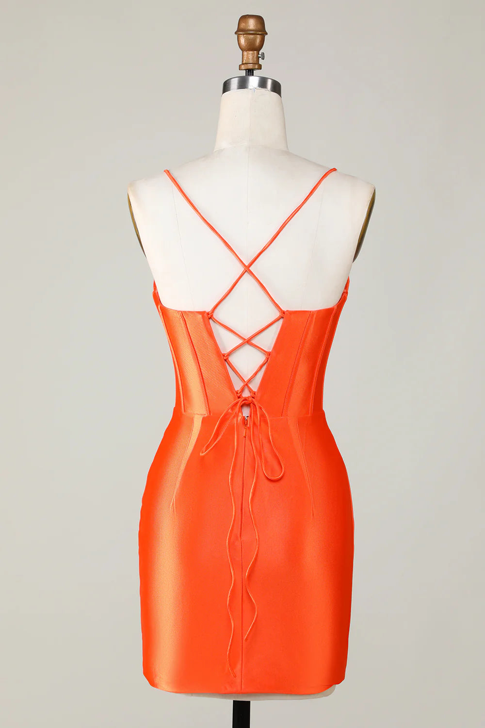 Side view of an orange beaded corset short dress, showcasing the fitted silhouette.
