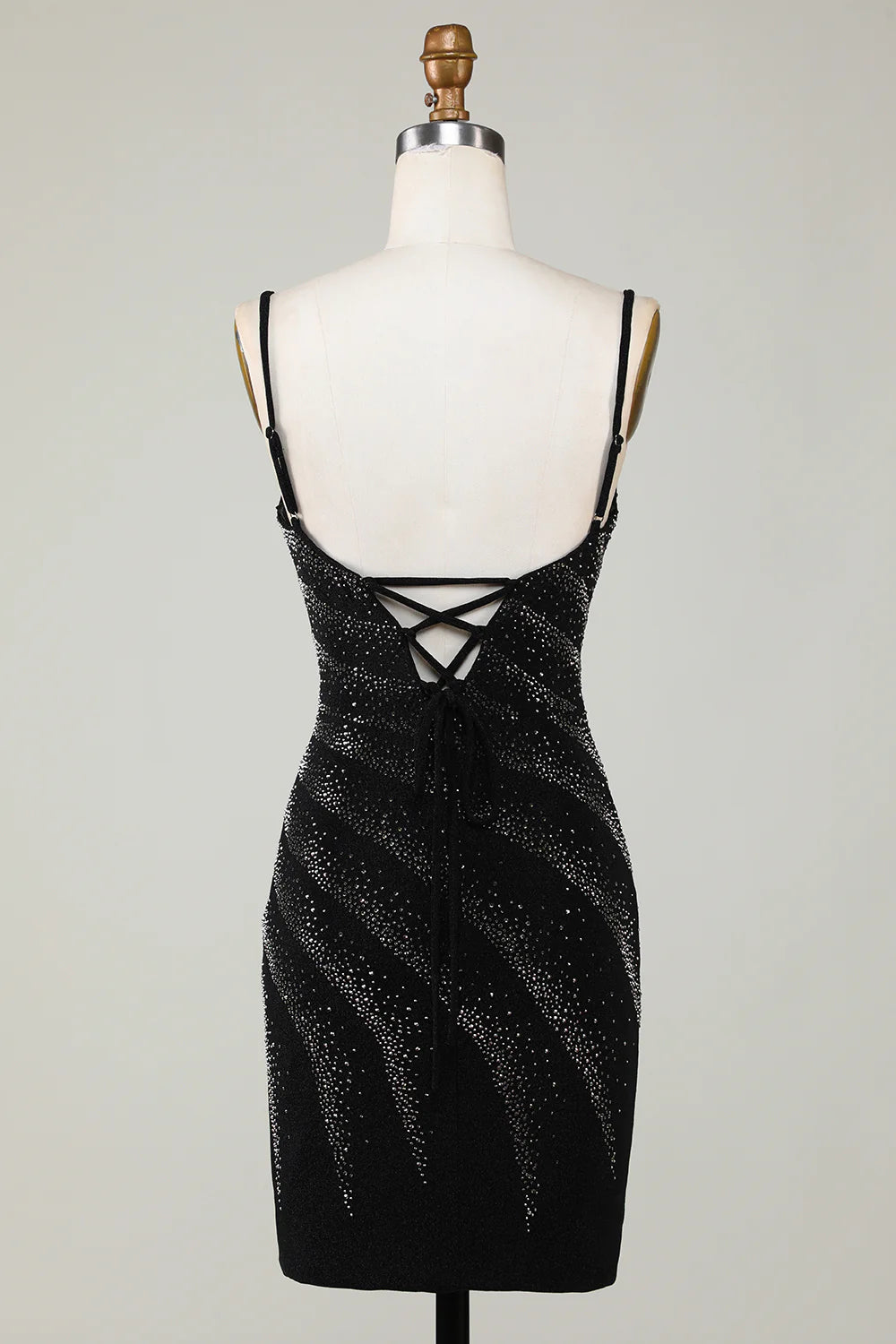 Close-up of the sparkling embellishments on the black V-neck dress.