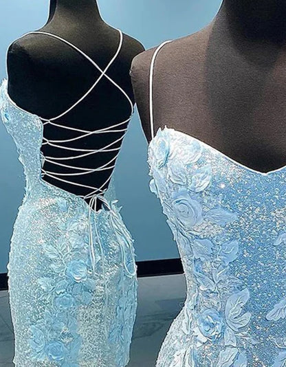 Close-up of the blue glitter fabric and delicate appliques on the tight homecoming dress.