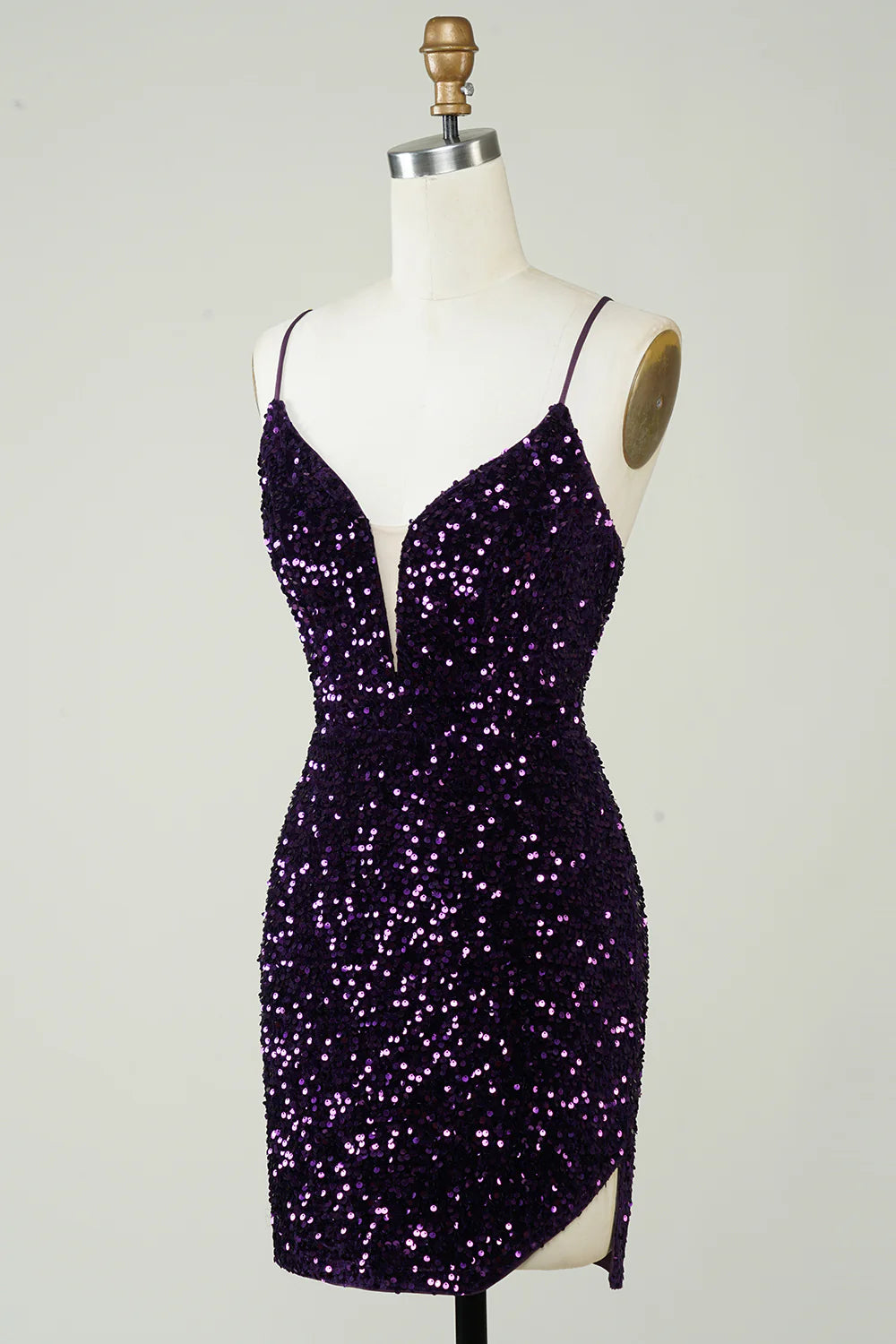 Side view of purple sequin dress highlighting the slit.