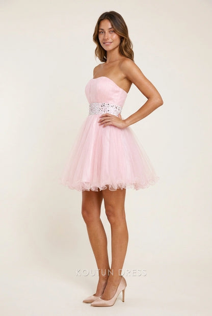 Detail of the rhinestone-embellished belt on a light pink A-line dress.