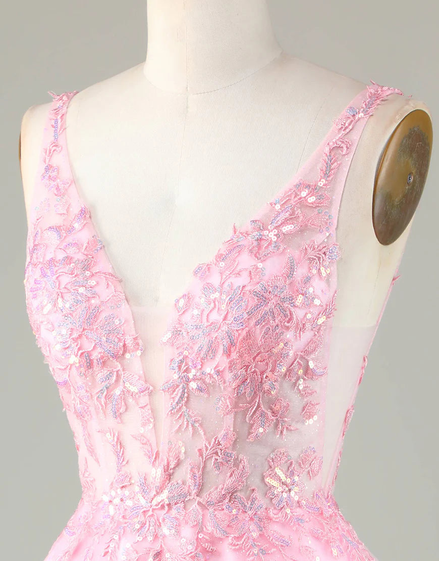 Close-up of the delicate appliques and shimmering glitter on the pink A-line homecoming dress.