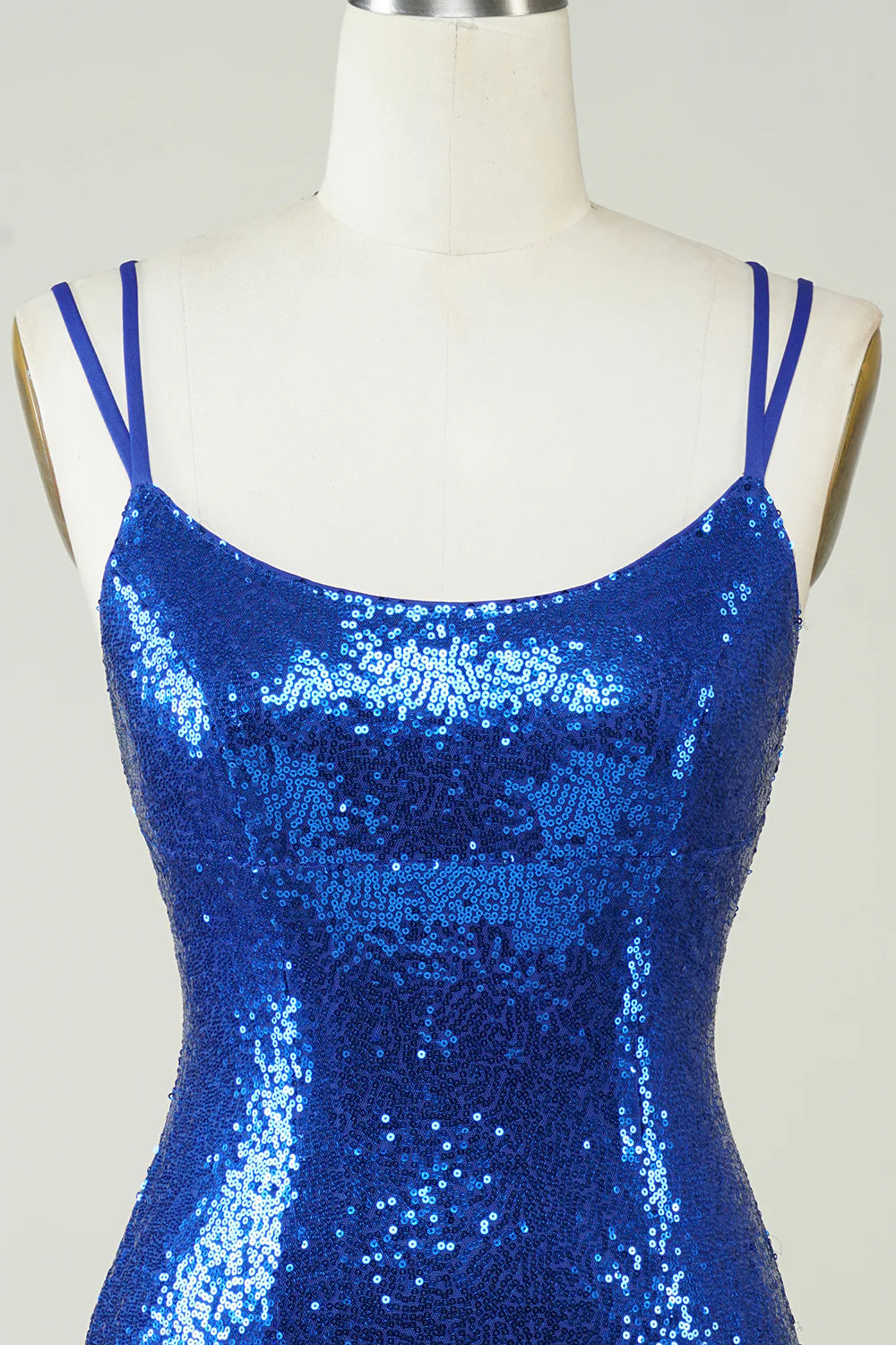 Model posing in a sparkling royal blue sequin sheath dress.
