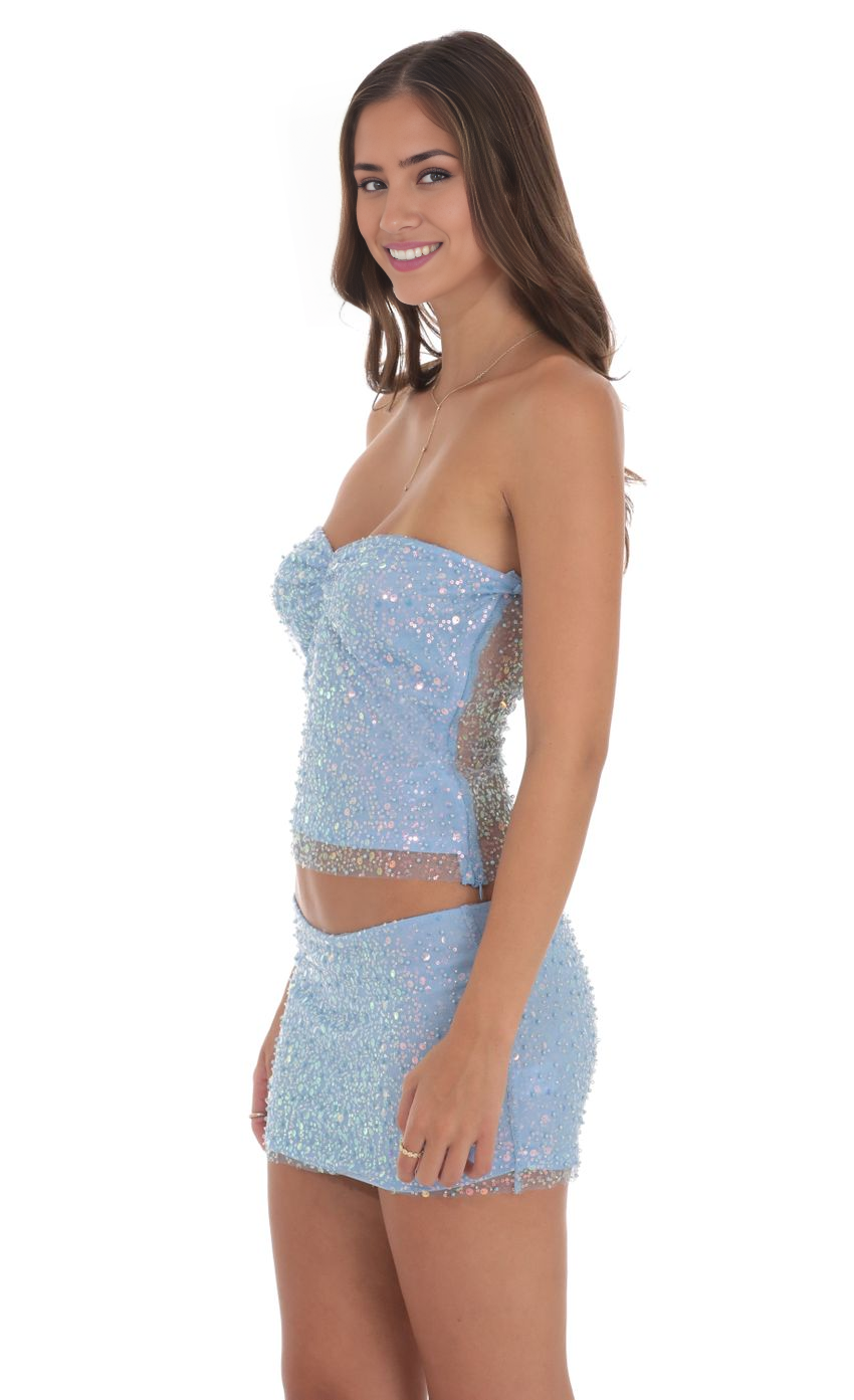 Close-up of the shimmering sequin and bead embellishments on the two-piece homecoming dress fabric.