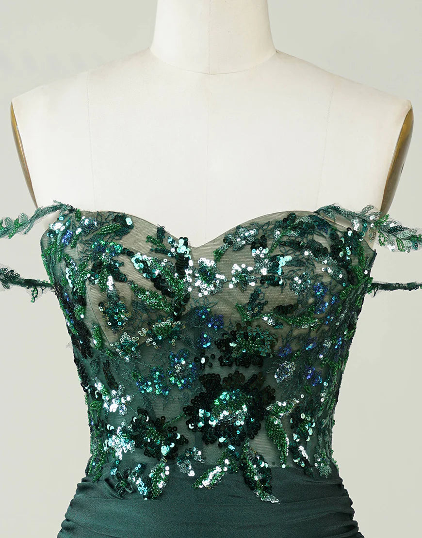 Close-up of sequin and applique details on the dark green dress.