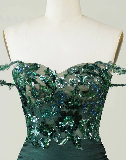 Close-up of sequin and applique details on the dark green dress.