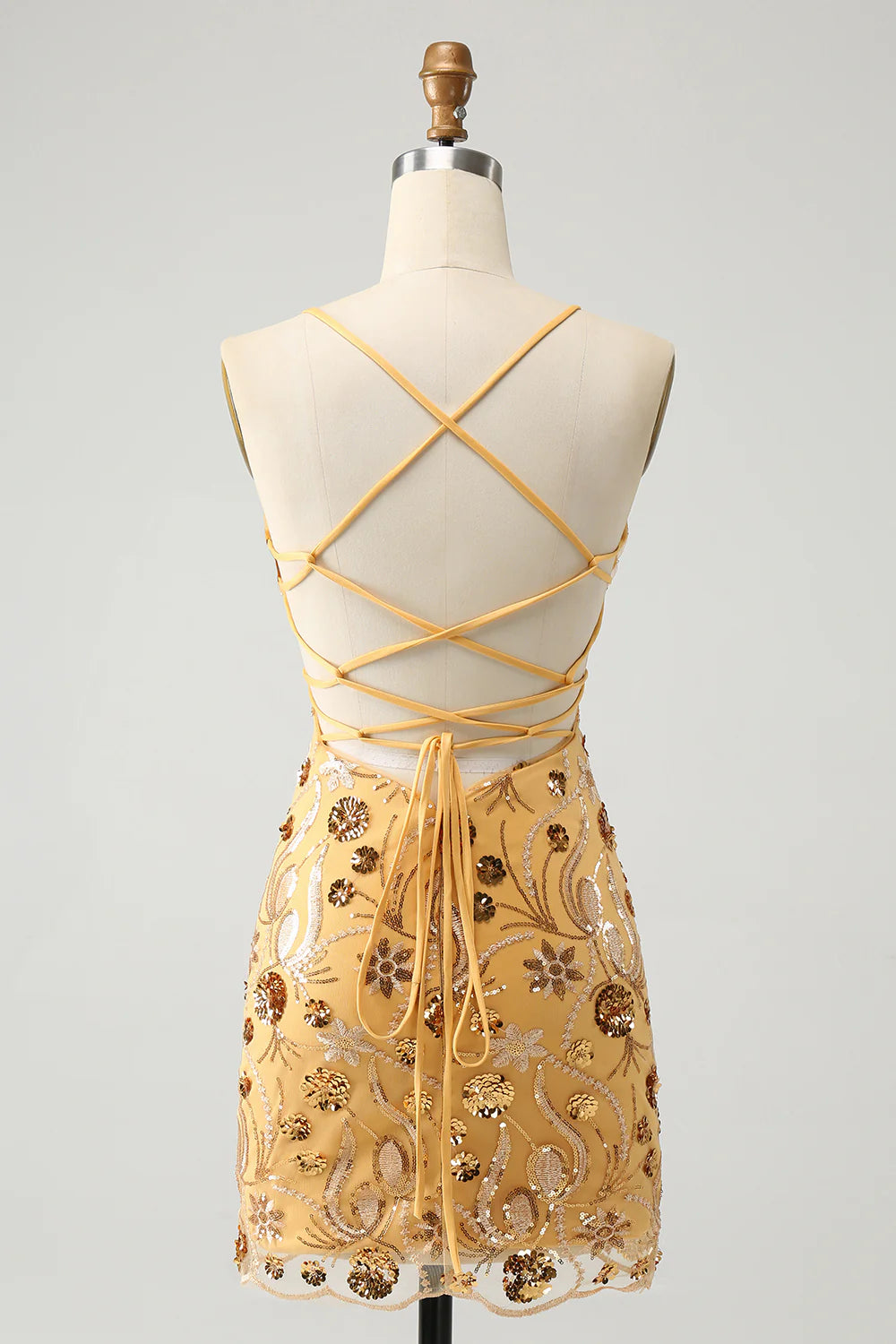 Side view of a woman in a yellow sequined homecoming dress.
