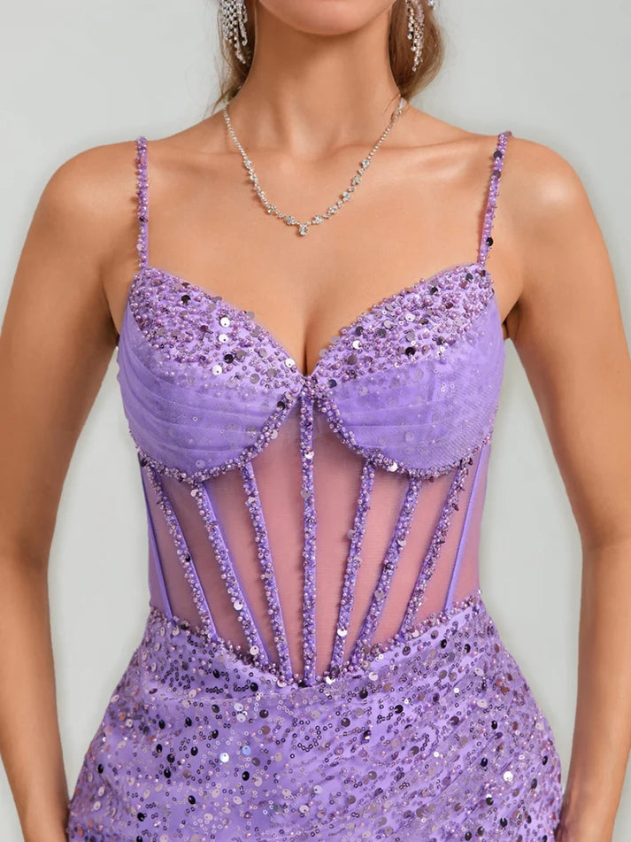 Close-up of intricate bead and sequin embellishments on a light blue dress.