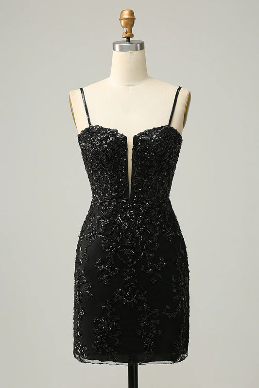 Model wearing a sparkling black sheath homecoming dress with V-neck and criss-cross back.