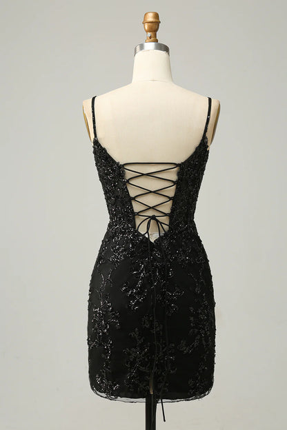 Back view of a black sequined sheath dress with criss-cross straps.