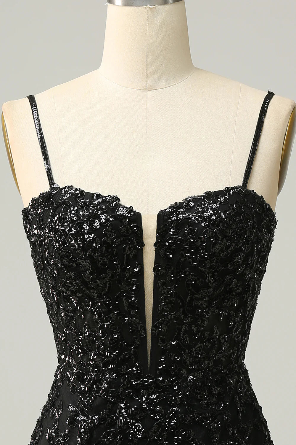 Close-up of the black sequin fabric on the dress.