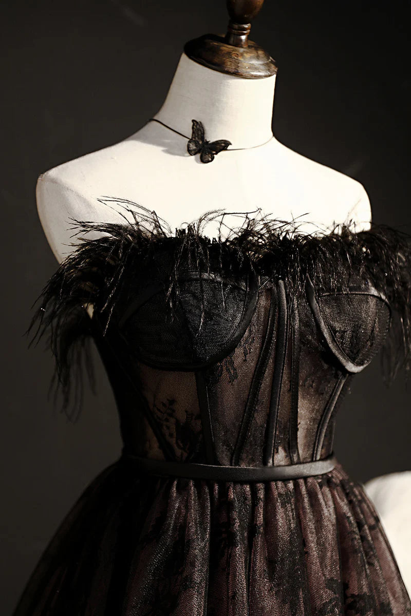 Back view of a black strapless A-line tulle short dress.
