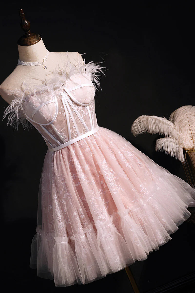 Side view of a black strapless A-line tulle short dress.