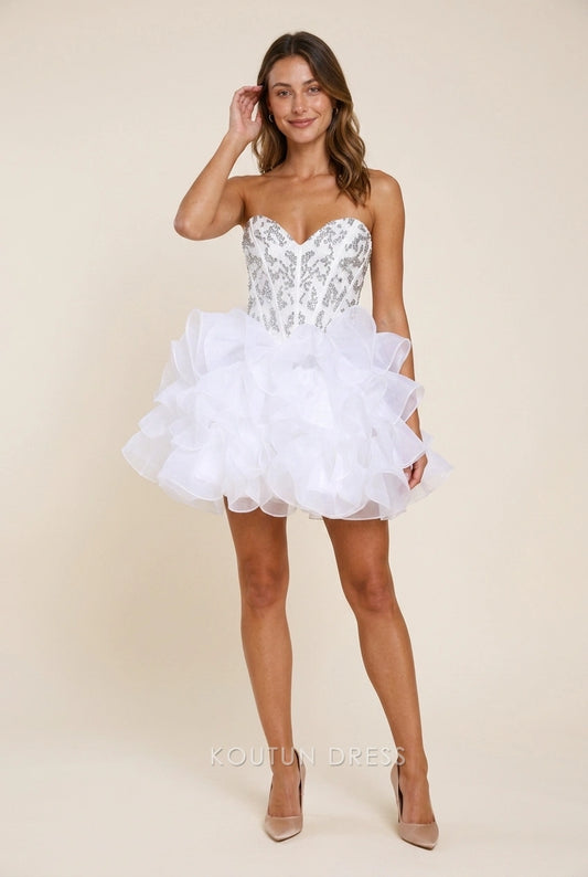 Model wearing a sparkling white strapless sequin ruffled short homecoming dress.