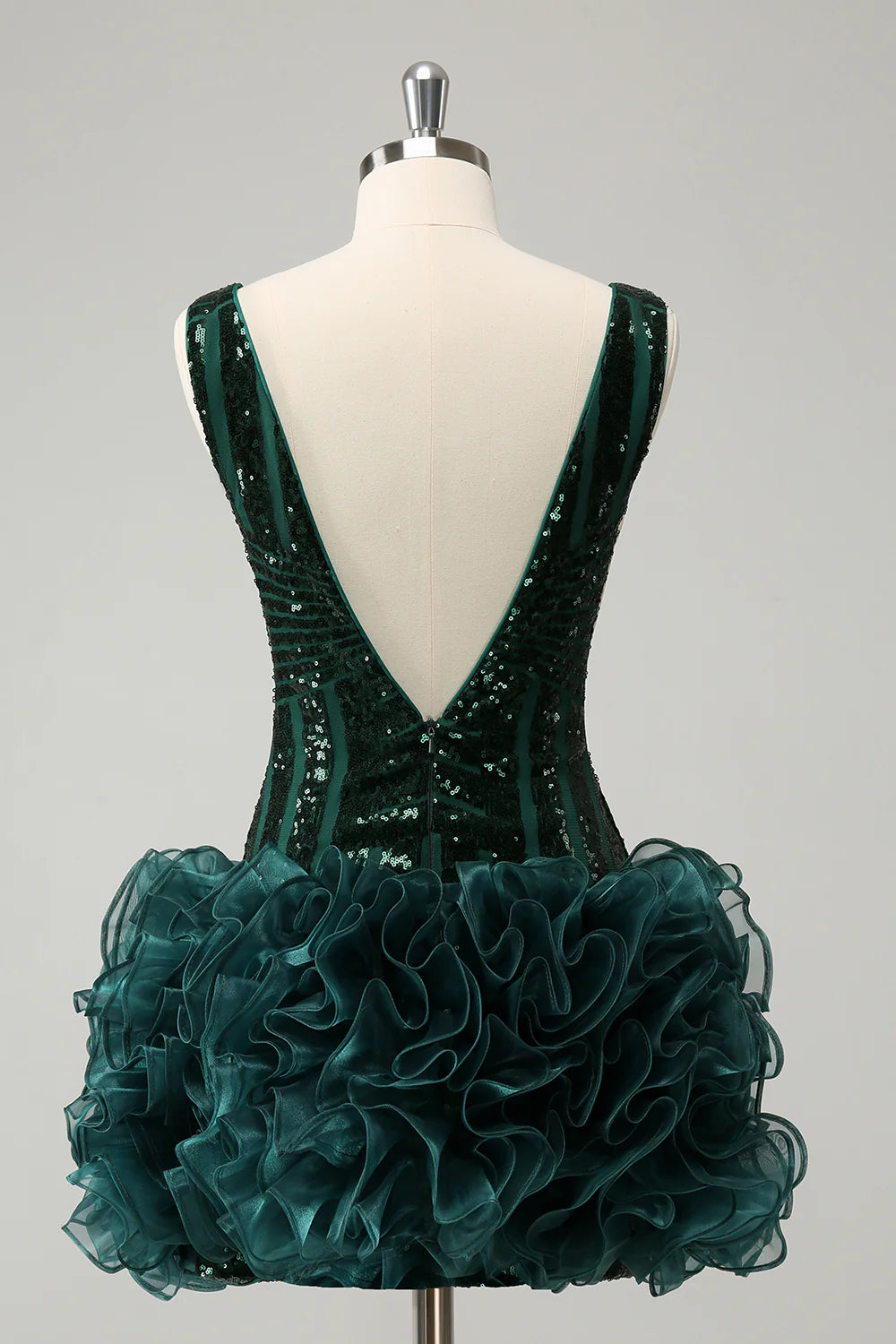 Close-up of the dark green sequin fabric and V-neckline.