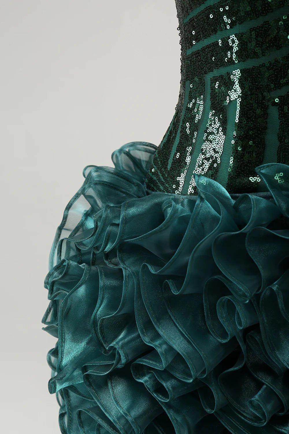 Back view of the dark green sequin dress, showing the flow.