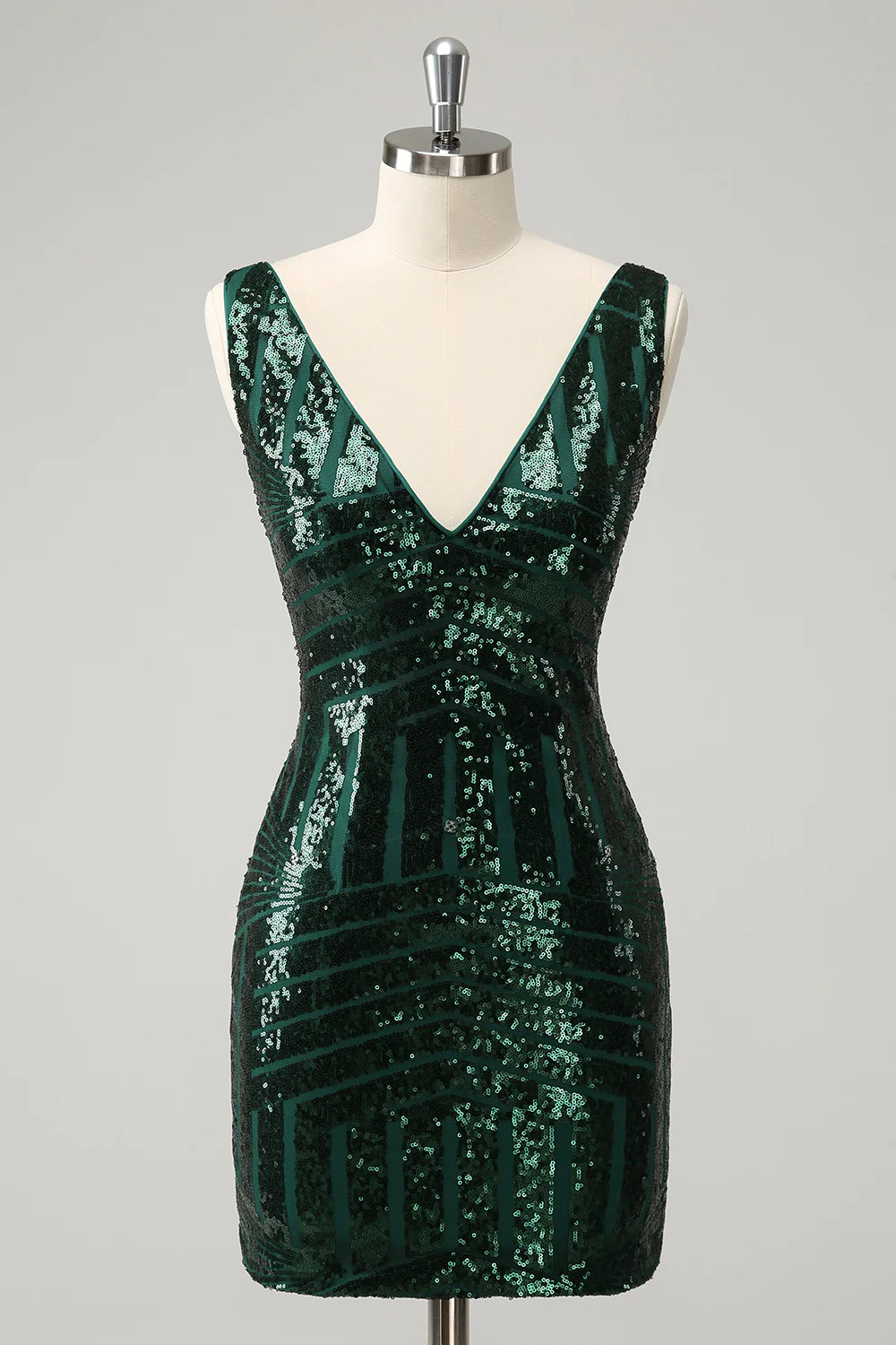 Model posing in the dark green sequin dress, highlighting detachable ruffles.
