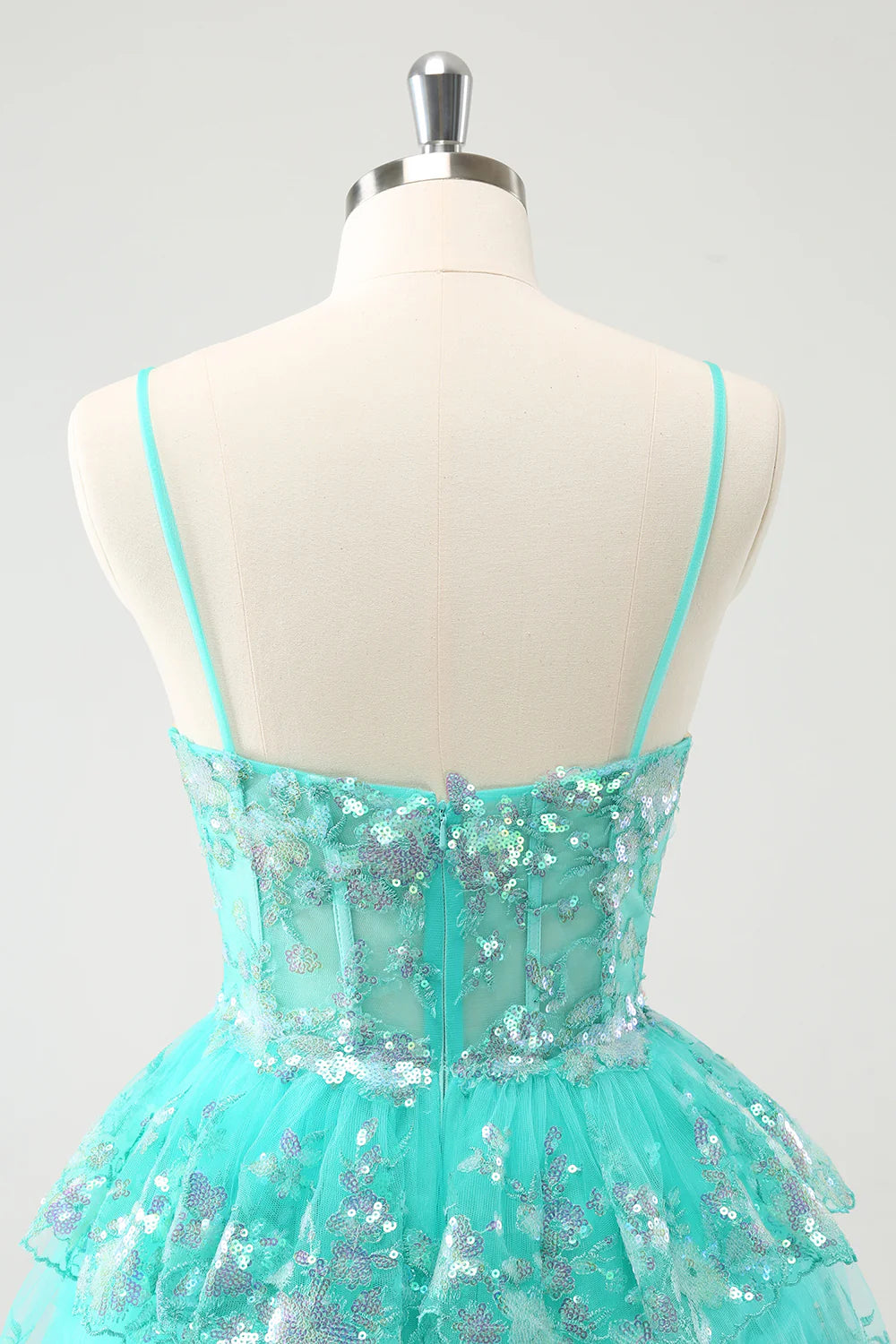 Another angle of the sparkly green tiered sequin dress, perfect for formal events.