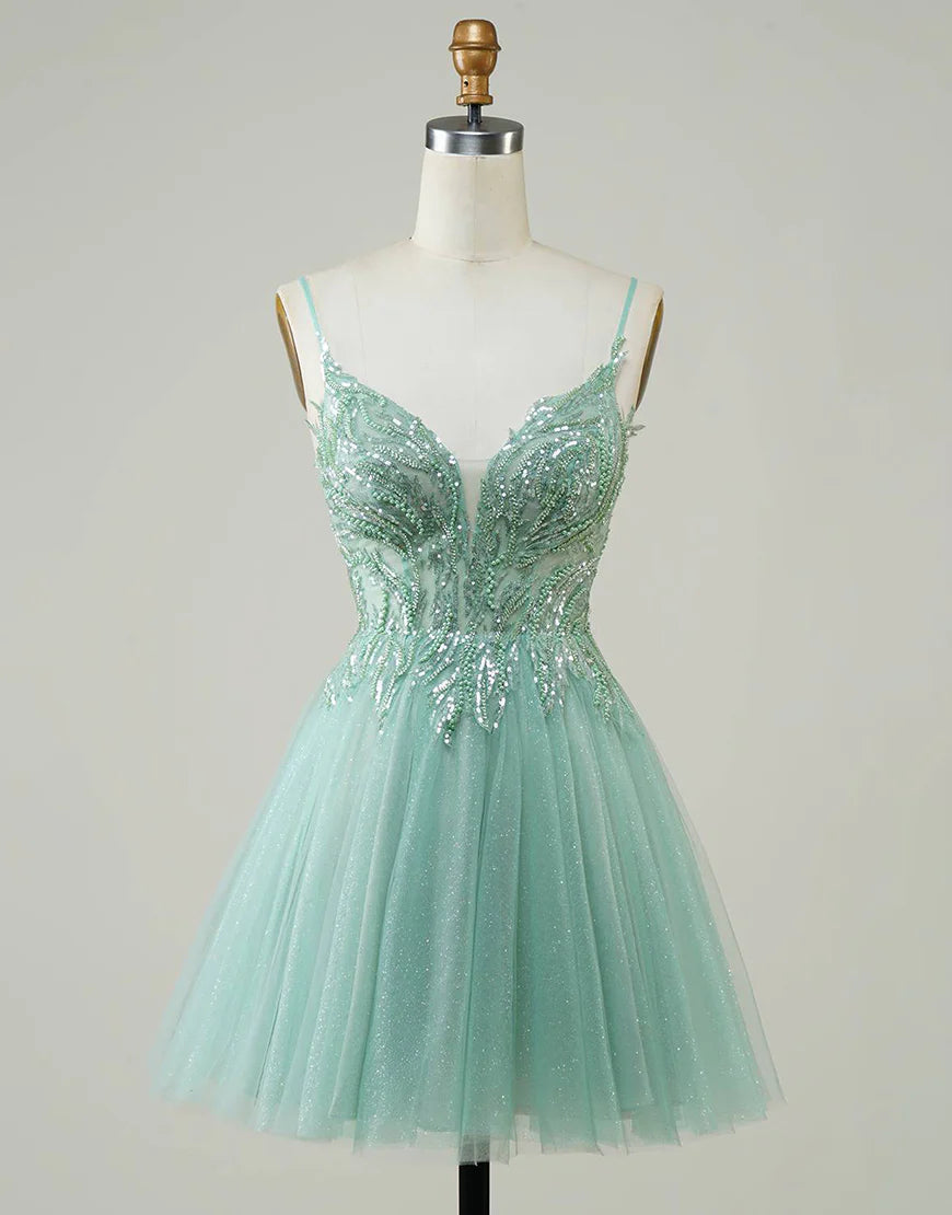 Model wearing a sparkly A-line green homecoming dress with beaded details.