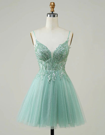 Model wearing a sparkly A-line green homecoming dress with beaded details.
