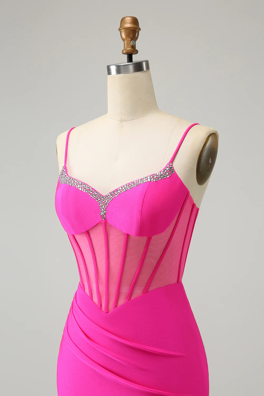 Close-up of beaded corset detail on fuchsia dress.