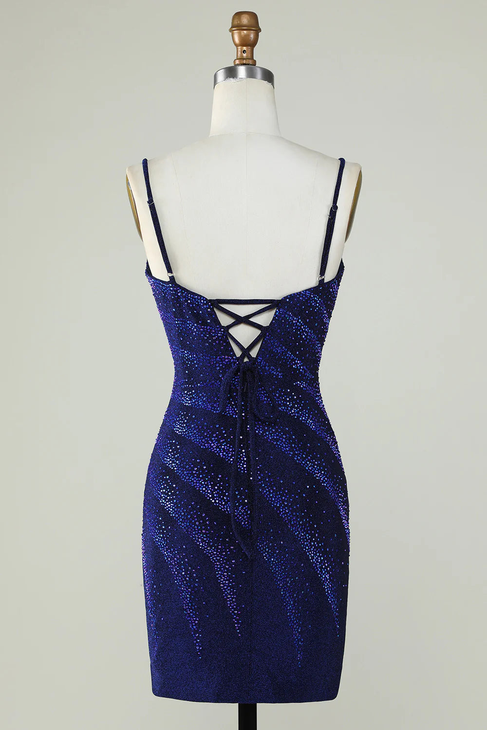 Side view of a woman wearing the royal blue sparkly formal dress.