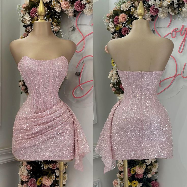 Pink strapless corset homecoming dress with sparkly sequins and side-draped mini skirt.